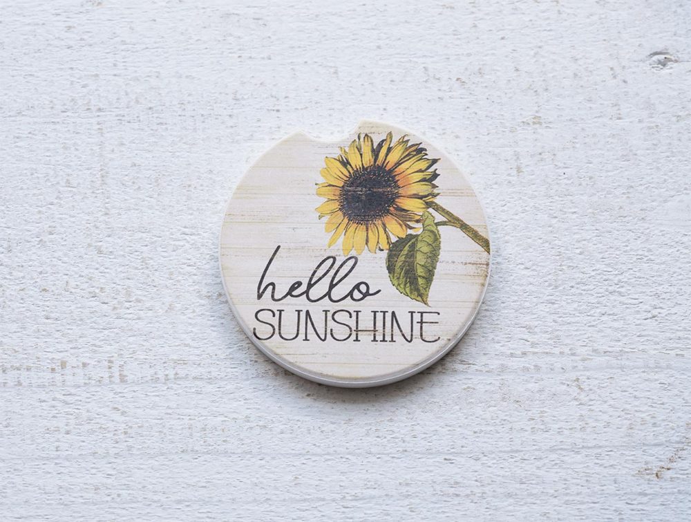 Counterart and Highland Home Hello Sunshine car coasters on a white rustic top