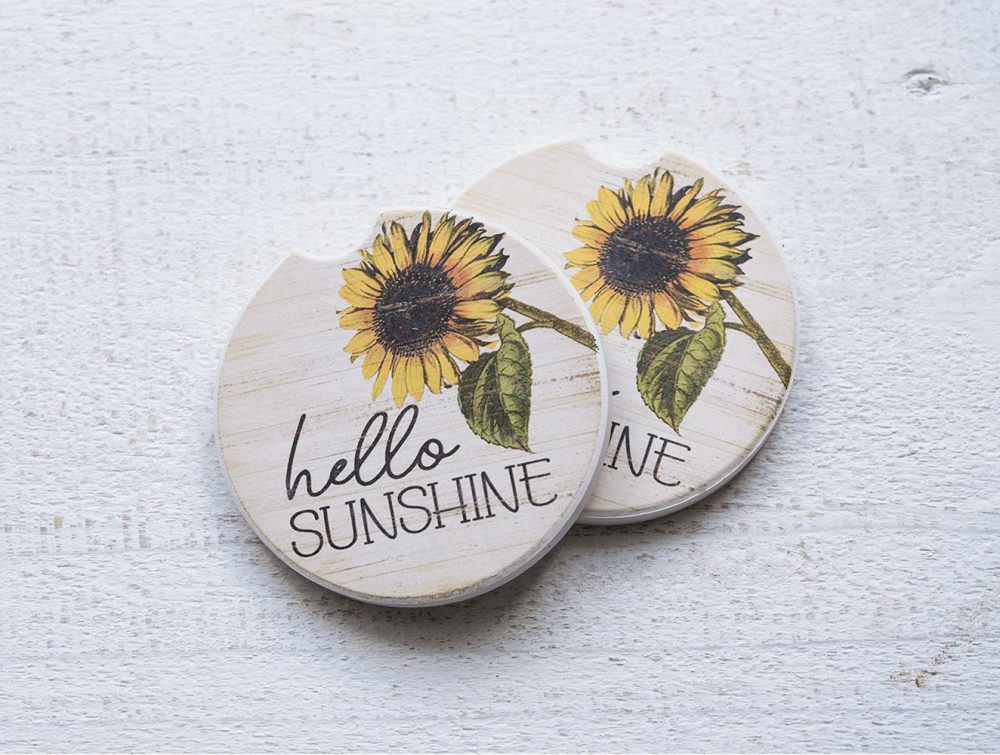 Counterart and Highland Home Hello Sunshine car coaster set on a white rustic top