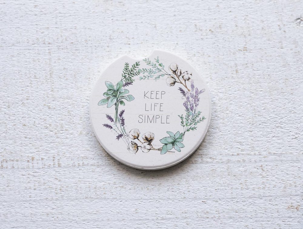 Counterart and Highland Home Keep Life Simple car coasters on a white rustic top