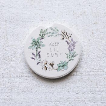 Counterart and Highland Home Keep Life Simple car coasters on a white rustic top