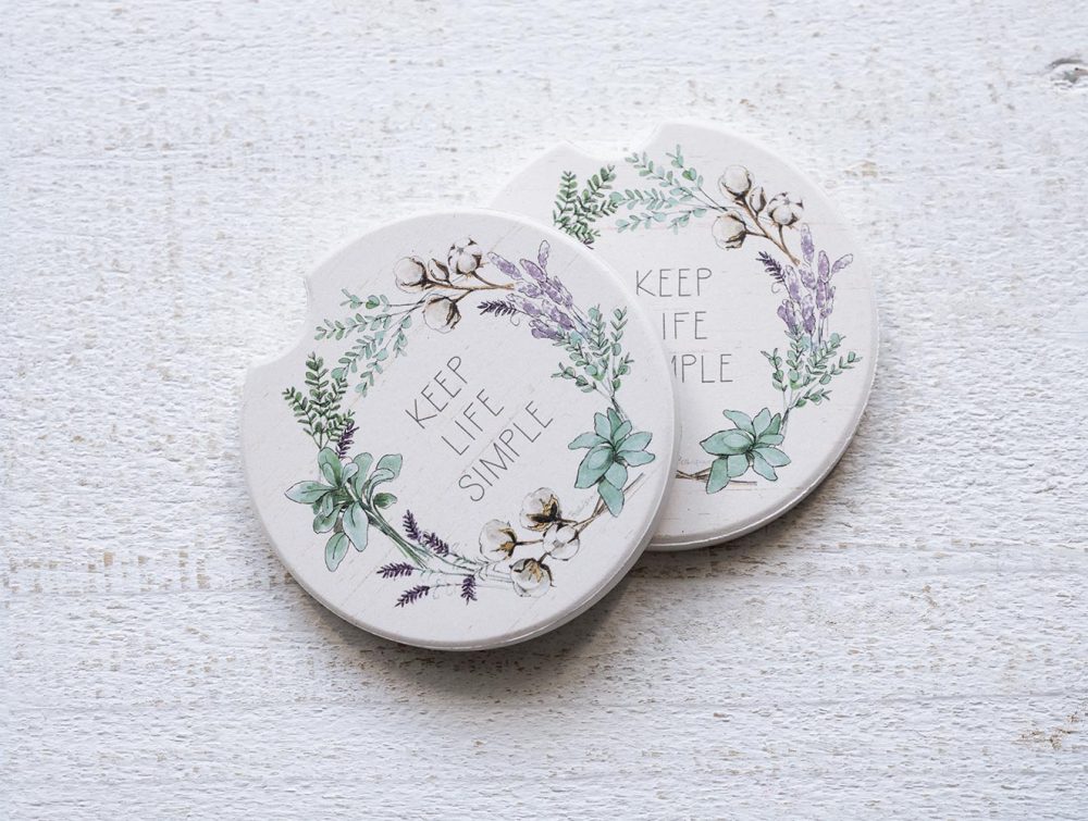 Set of Counterart and Highland Home Keep Life Simple car coasters on a white rustic top