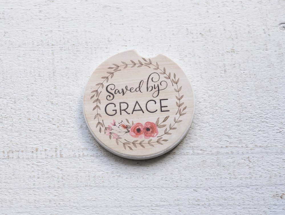 Counterart and Highland Home Saved by Grace car coaster on a white rustic top