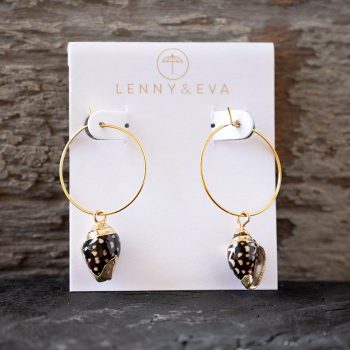 Front view of the Lenny & Eva brown shell earrings against a rustic wood backdrop