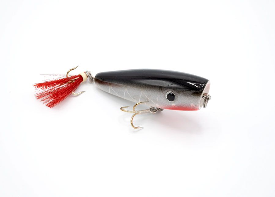 Upright view of JL Lures silver & gray with red tassel pine wood fishing lure
