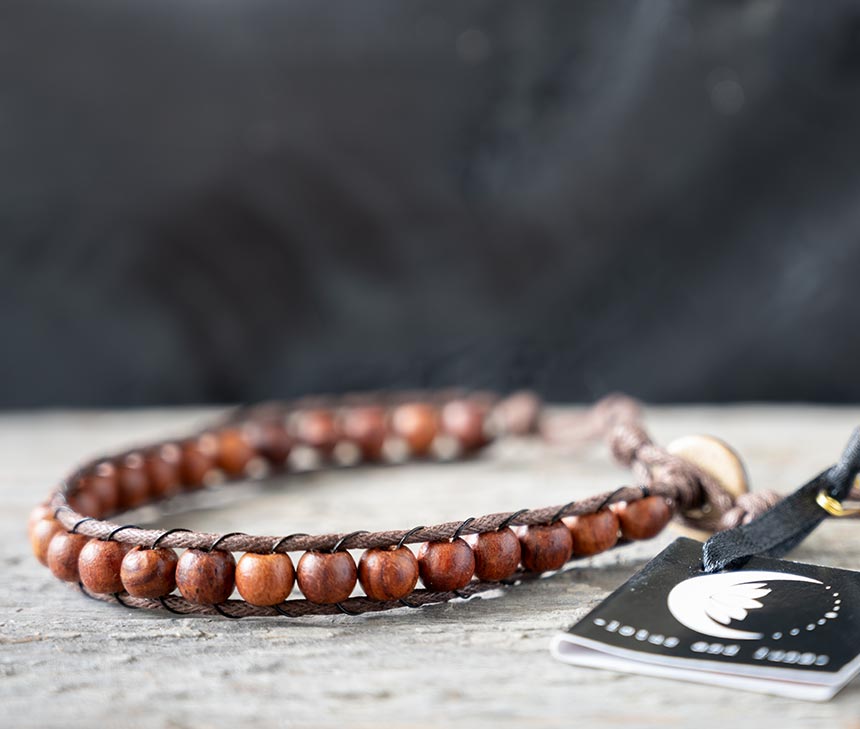 Side view of the Surf Rider Dawn Patrol men's bracelet on a rustic wooden backdrop