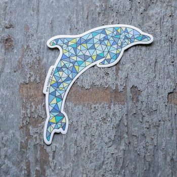 Colorful dolphin sticker by the Happy Sea on a rustic piece of wood