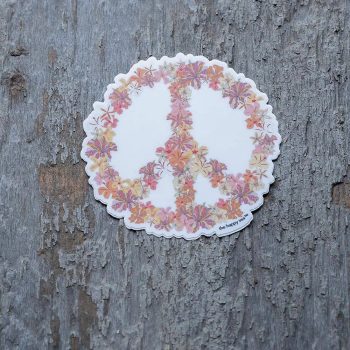 Colorful hibiscus flower peace sign sticker by The Happy Sea on a rustic piece of wood