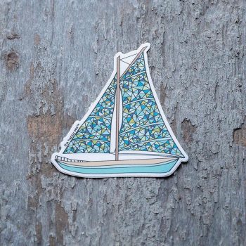 Colorful sailboat sticker by The Happy Sea on a rustic piece of wood