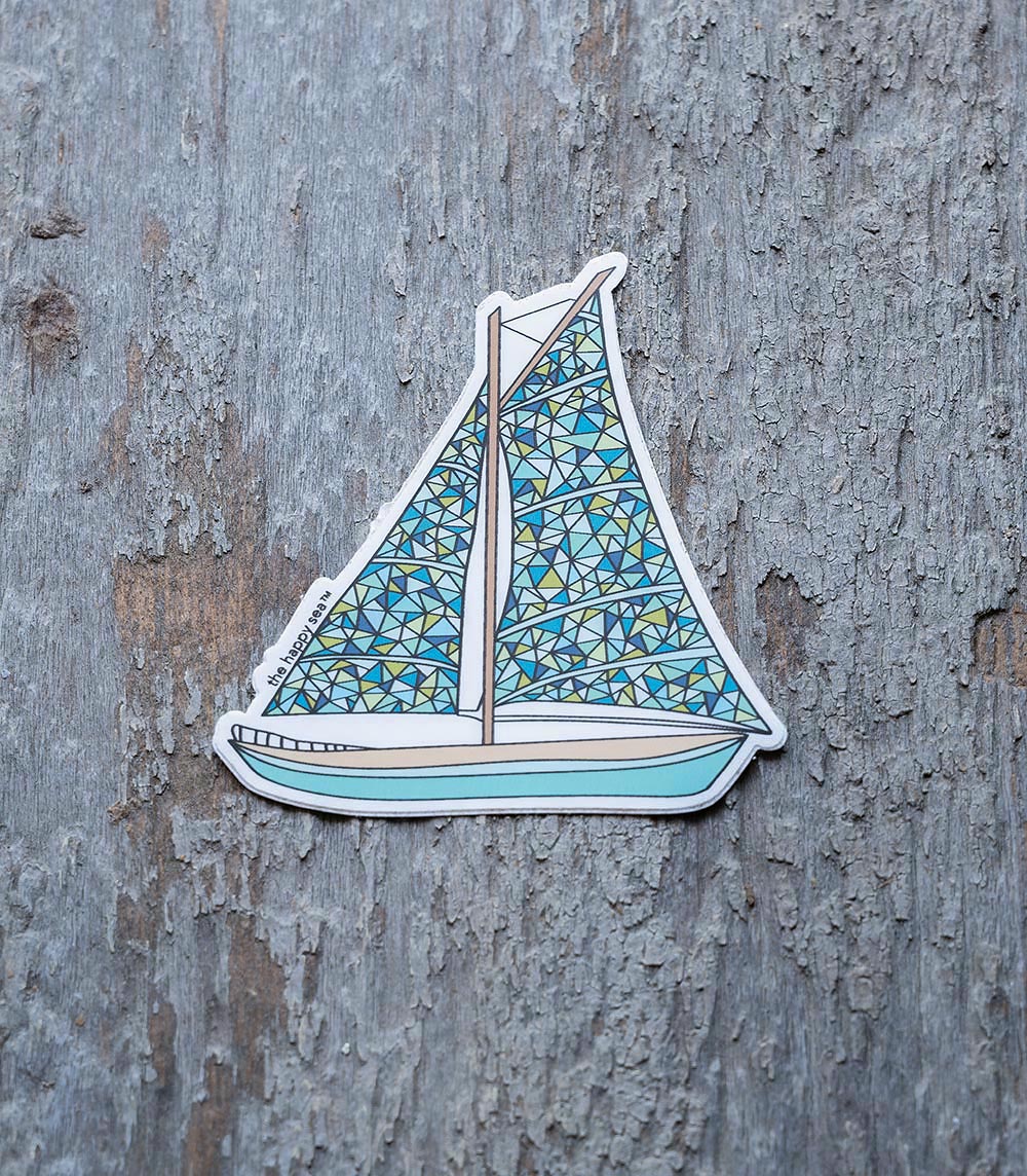 Colorful sailboat sticker by The Happy Sea on a rustic piece of wood