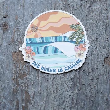 The Ocean is Calling die-cut sticker on a rustic piece of wood