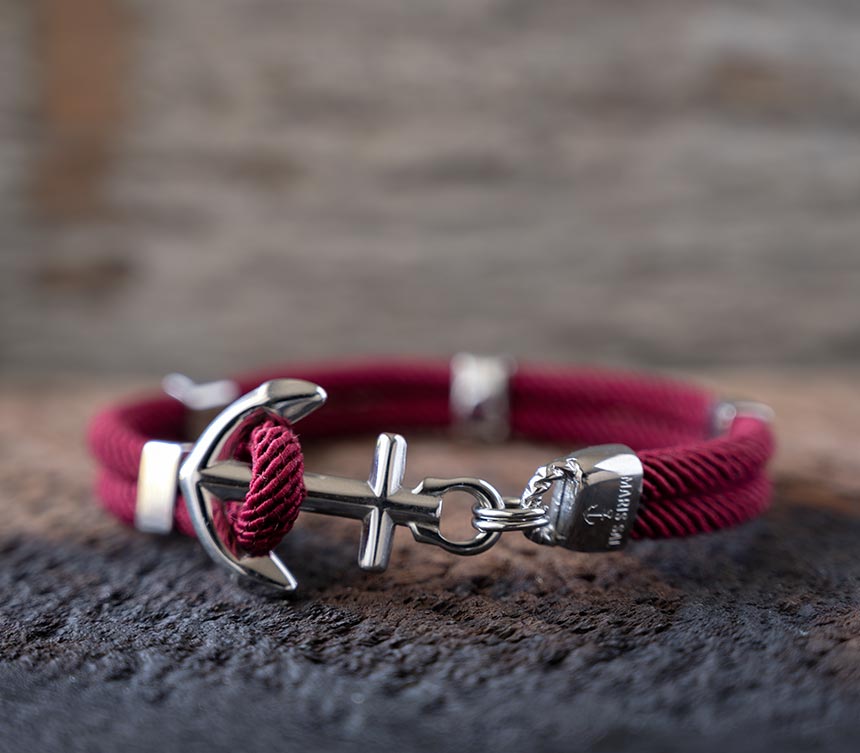 Front view of the Women’s Maris Sal Nautical Anchored New Haven Bracelet in Bordeaux Bracelet on a Piece of Rustic Wood