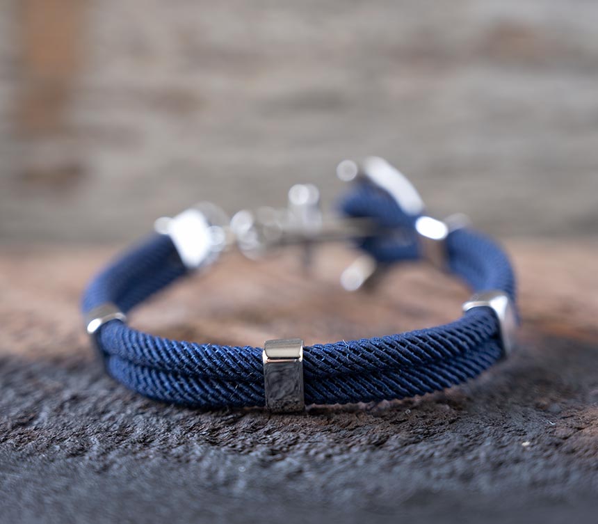 Back View of the Women’s Maris Sal Nautical Anchored New Haven Bracelet in Navy Bracelet on a Piece of Rustic Wood