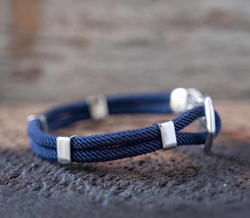 Right Side View of the Women’s Maris Sal Nautical Anchored New Haven Bracelet in Navy Bracelet on a Piece of Rustic Wood