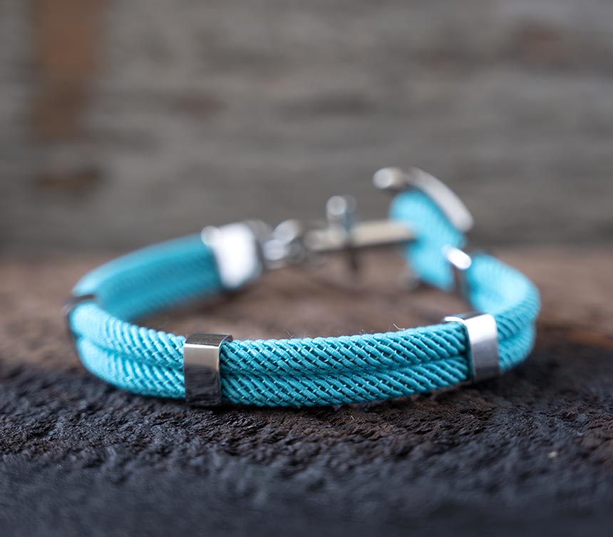Back View of the Women’s Maris Sal Nautical Anchored New Haven Bracelet in Turquoise Bracelet on a Piece of Rustic Wood