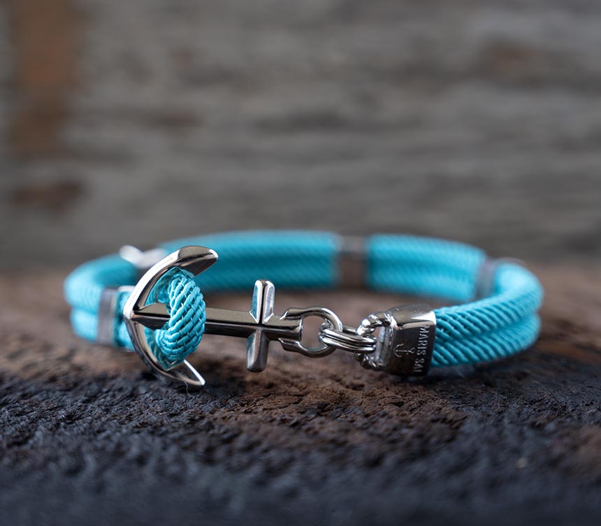 The Women’s Maris Sal Nautical Anchored New Haven Bracelet in Turquoise Bracelet on a Piece of Rustic Wood