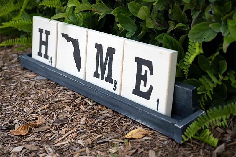 Angled view of the Wooden letter tile trays with the saying Home with the State of Florida as the O