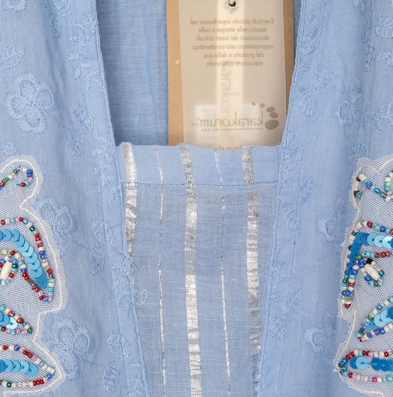 Closeup view of the Karakorum Granada Kaftan fabric and tag