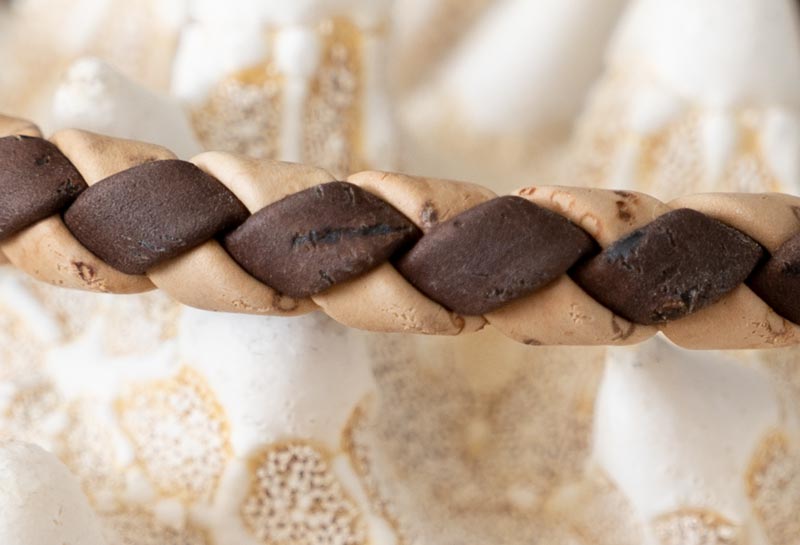 Closeup view of the Cork Tree Designs two tone weaved cork bracelet