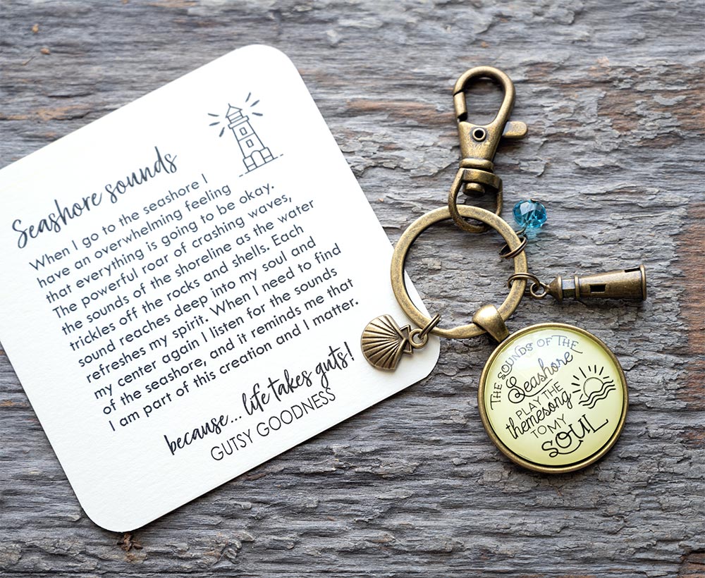 Sounds of the seashore keychain with card by Gutsy Goodness on a rustic piece of wood