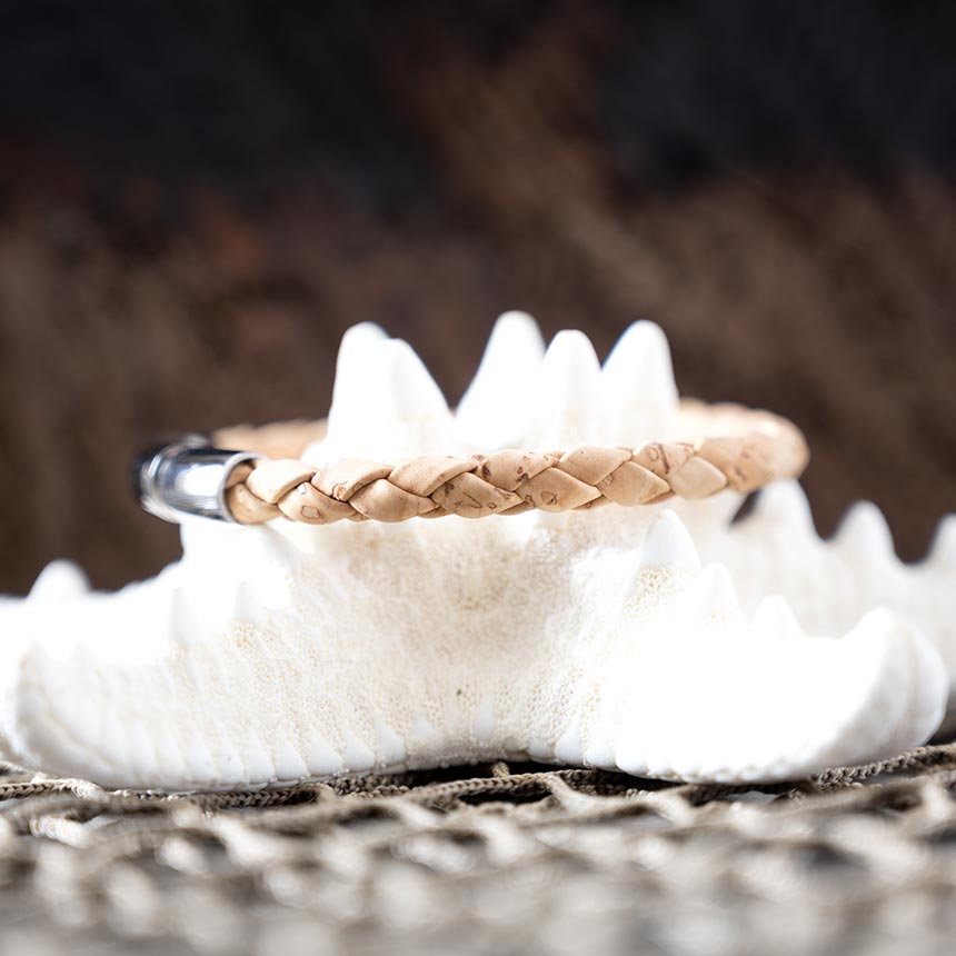 Left side view of the men's Cork Tree Designs Corked weaved natural bracelet on a starfish