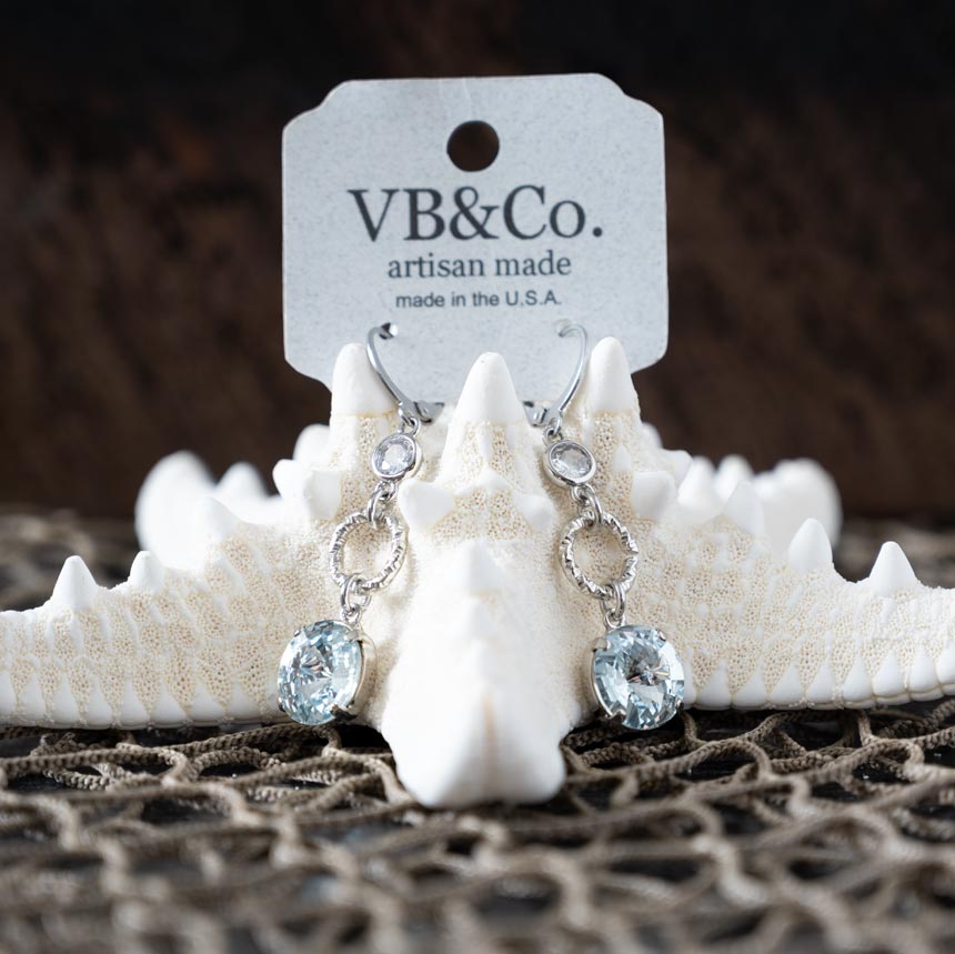 Front view of the blue Swarovski earrings by VB&CO on a starfish