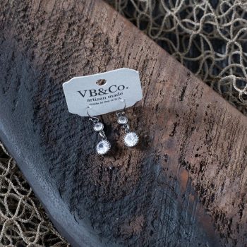 Top view of the rustic crystal earrings by VB&CO on a piece of wood