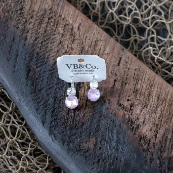 Top view of the pink Swarovski earrings by VB&CO on a piece of wood