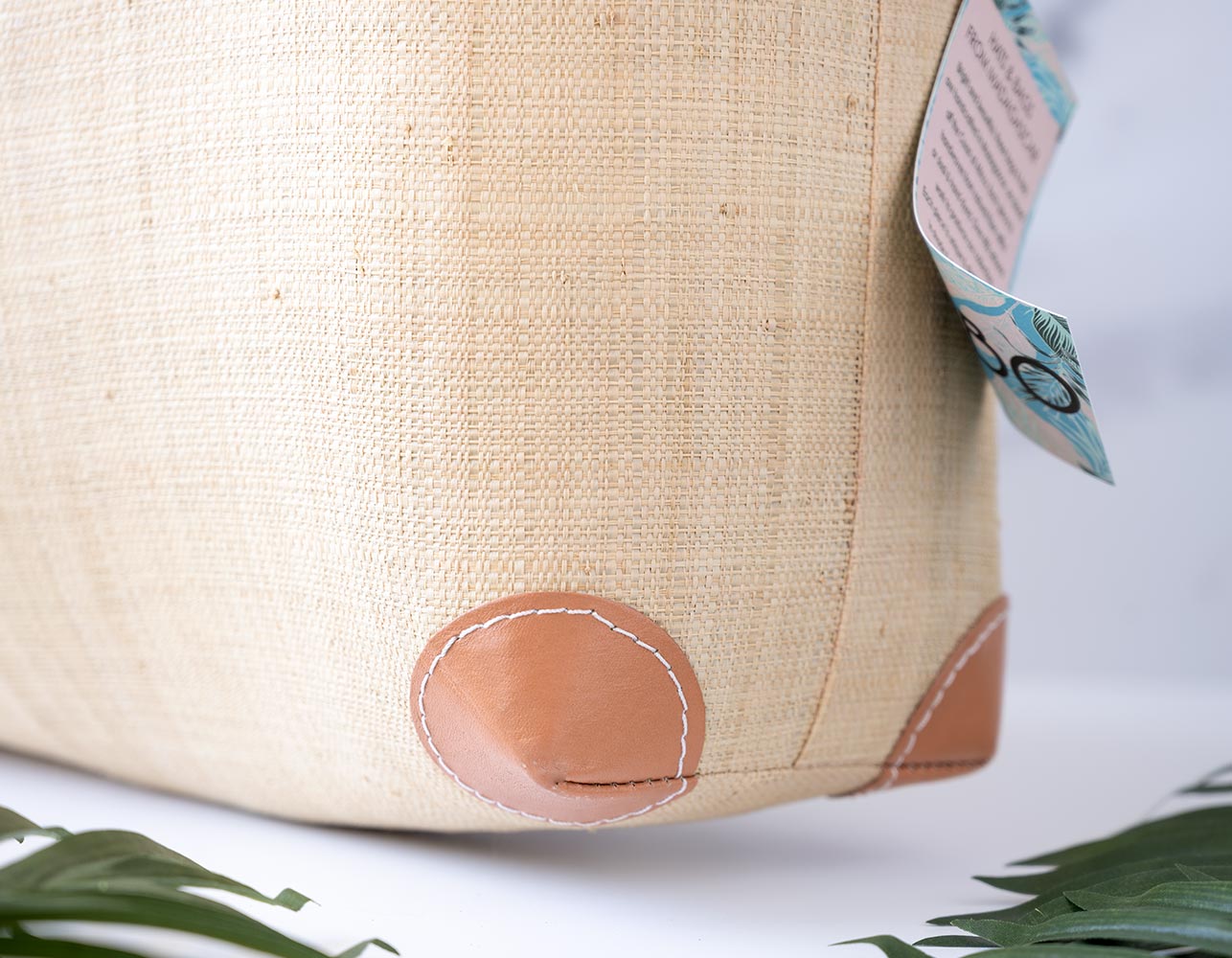 Lower Corner View of the Shebobo Bebe Straw Bag with Bamboo Handles