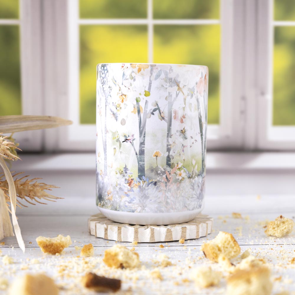 Front view of the Flower Forest mug by Florae & Snow with a Flal window backdrop and biscotti pieces