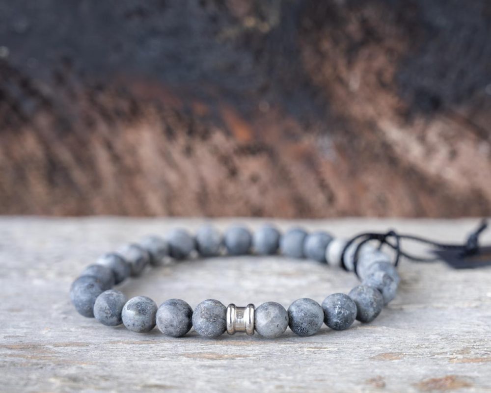 Back view of the Steel and Barnett Matt Lavikite Stones Beads Bracelet on and against a rustic wood backdrop