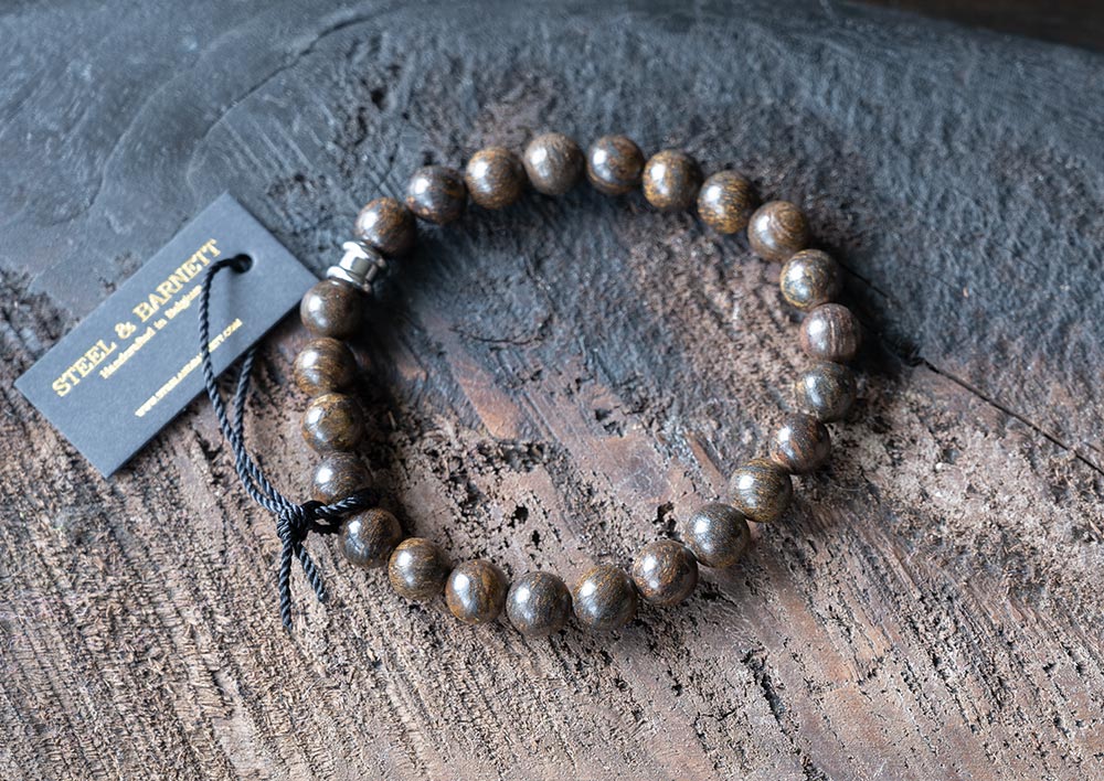 Top View of the Steel and Barnett Bronzite Stones and Beads Bracelet on top of a wood backdrop