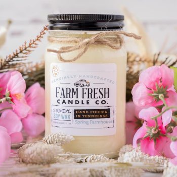 View of the Farm Fresh Candle Co Spring Farmhouse candle with Spring props and rustic backdrop