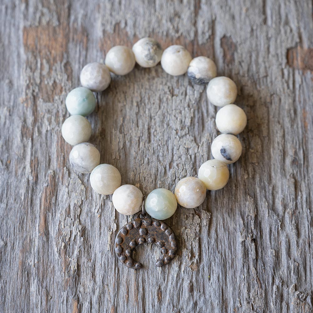 Top view of the VB&CO Beaded Amazonite Bracelet with Moon Charm on Rustic Wood