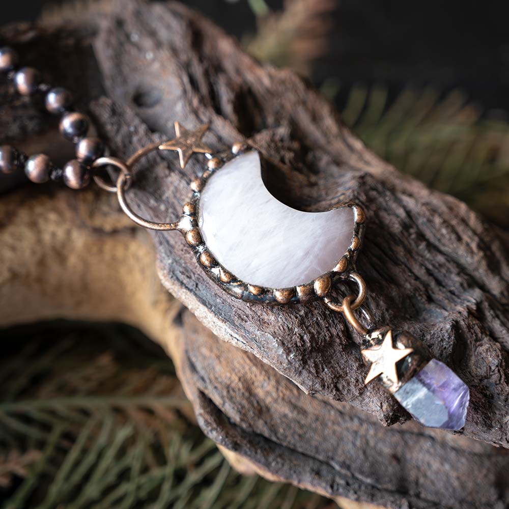 Top view of the moon charm, stone and beads VB&CO Luna Moon Boho bracelet on a wooden backdrop