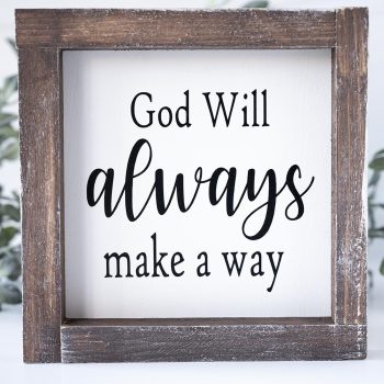 Joshua Jar God Will Always Make a Way wood sign against a white backdrop and greenery