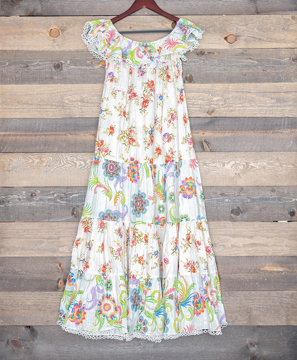 Back view of Ranee's White Cotton Lurex Floral Dress against a wooden backdrop
