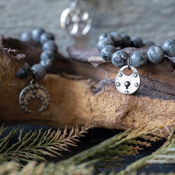 The VB&CO Designs labrodite beaded bracelet collection with leaves and wood backdrop