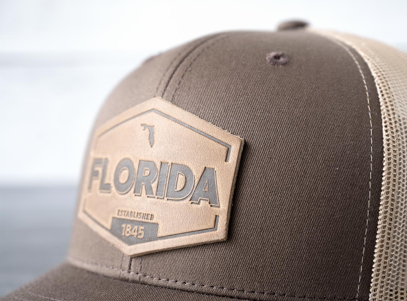 Closeup View of the RANGE Leather Florida Established Hat in Brown & Khaki