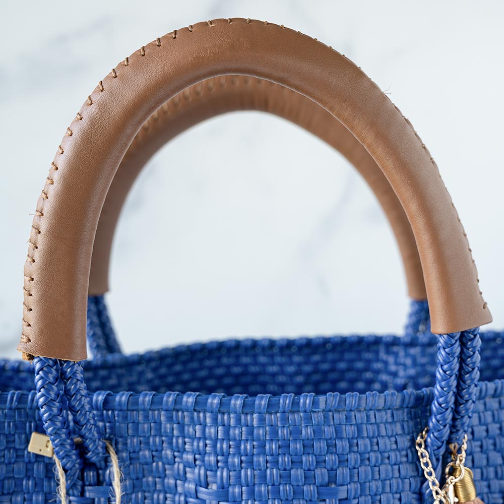 Closeup View of the Leather Handles on the Mavis by Herrera Hannah Resort Tote Bag in the Color Ocean Blue