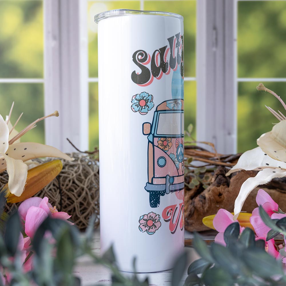 Right view of the Emma K Designs Beach Vibes Skinny 20 oz. tumbler on rustic backdrop with window and flowers