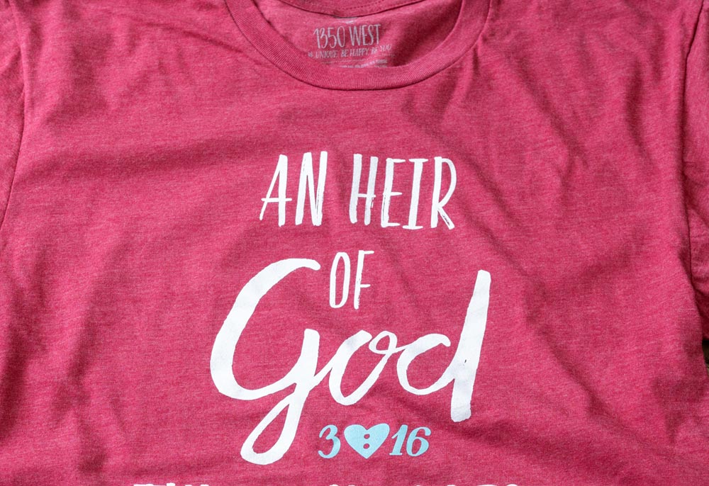 Closeup View of An Heir of God Through Christ Premium Graphic Tee in the color Cardinal by 1350 West Boutique & Gallery