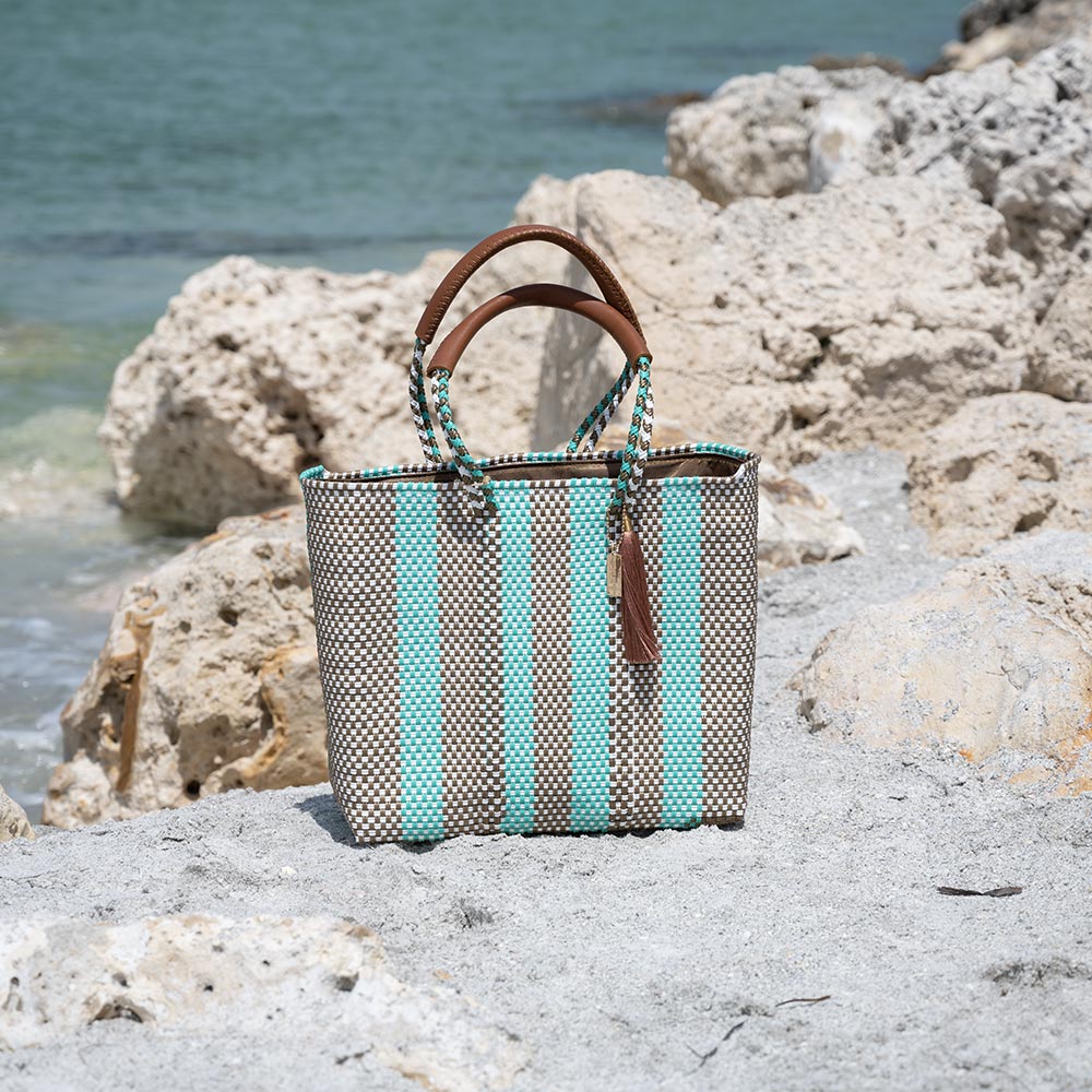 Front View of the Mavis by Herrera Hannah Resort Tote Bag in the Color Bora Bora at the Beach
