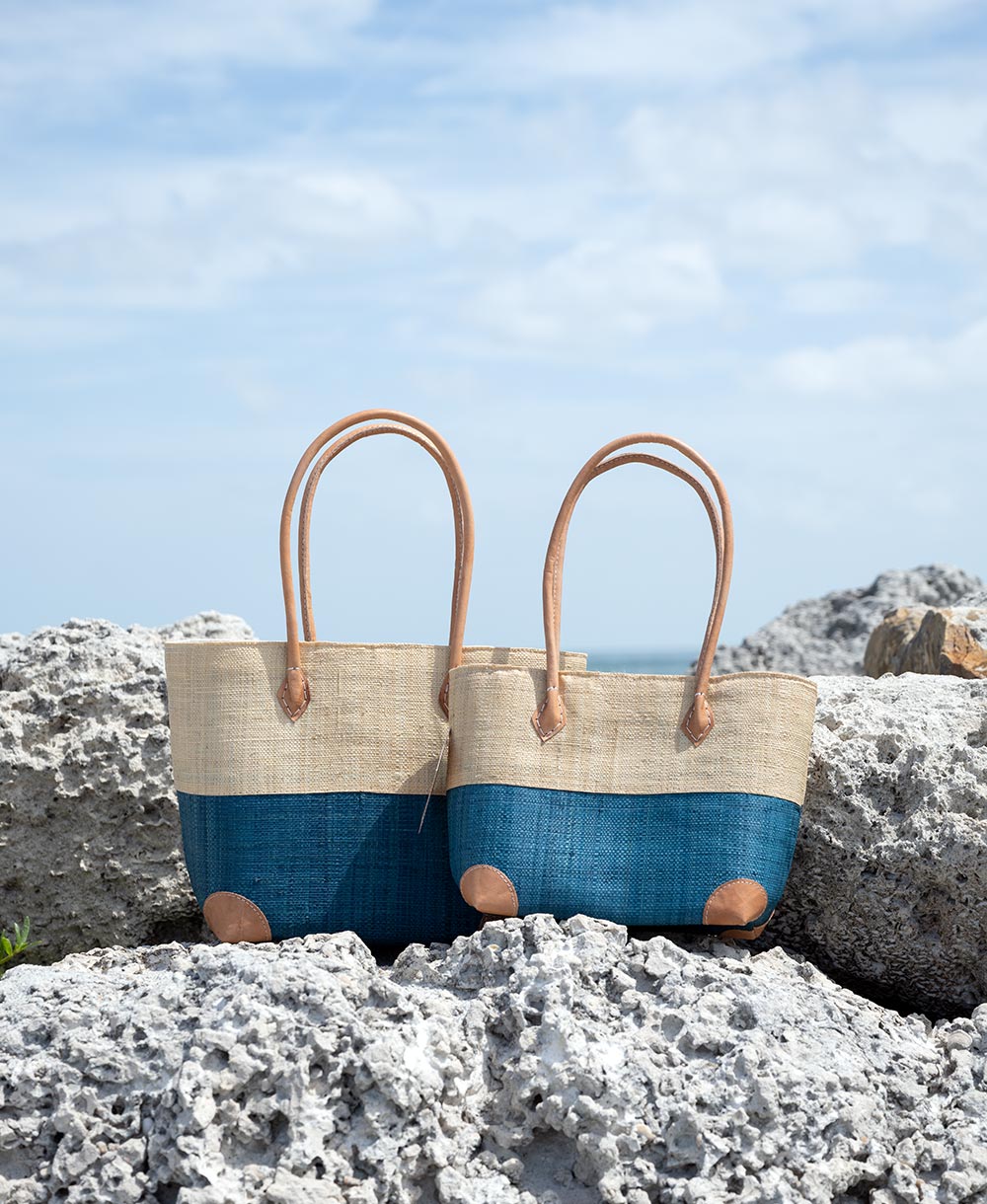 Perfect Pairing of the Shebobo Trinidad Two Tone Tote Bag in the color aqua in sizes small & medium at the beach on rocks