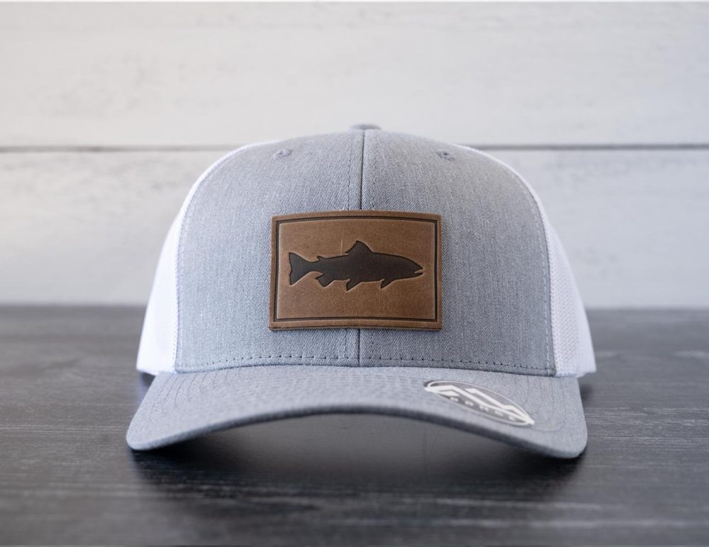 Front view of the RANGE Leather Trout hat in the color heather gray & white against a white and black rustic wood background