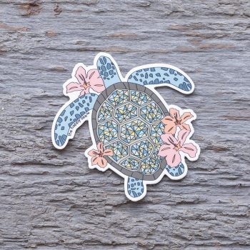 Top view of the Happy Sea Hibiscus Turtle sticker on a rustic wood background