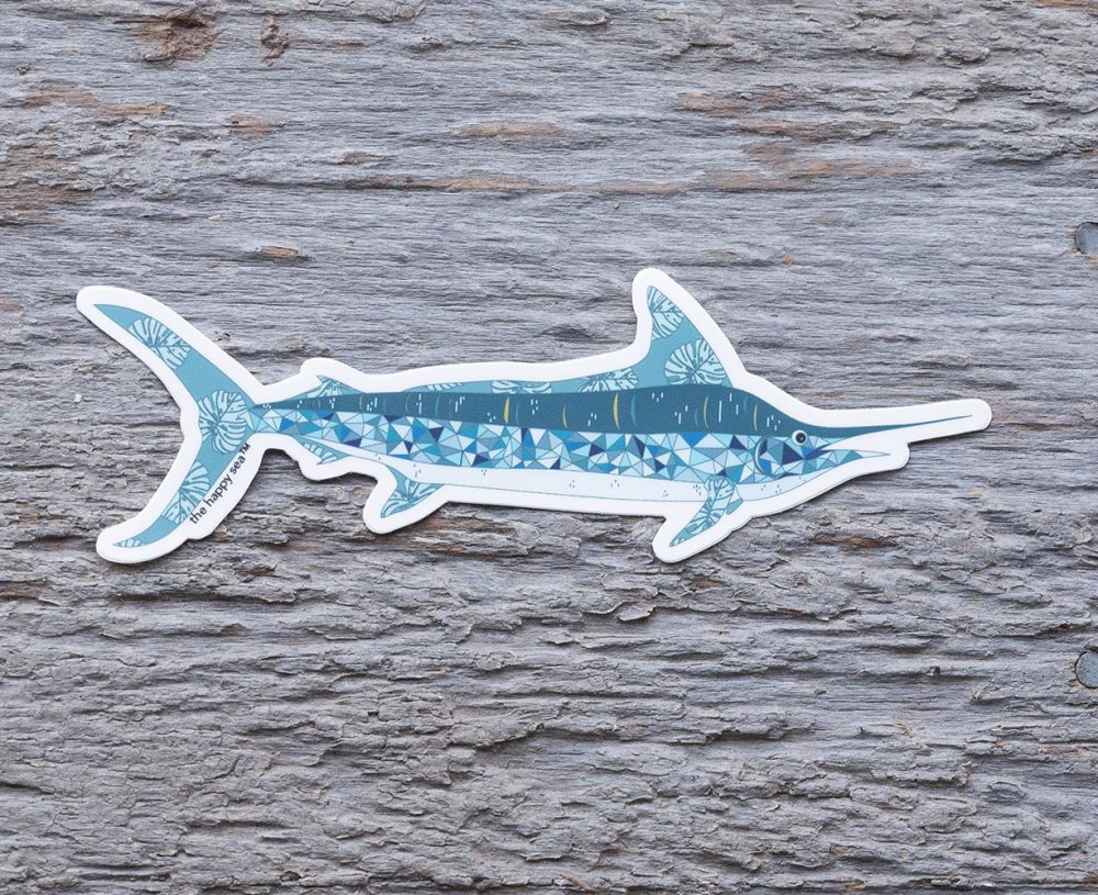 Top view of the Happy Sea Marlin sticker on a rustic wood background
