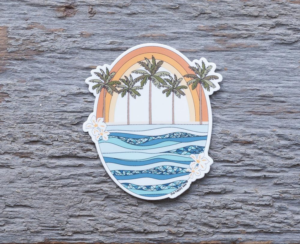 Top view of the Happy Sea Retro Rainbow sticker on a rustic wood background