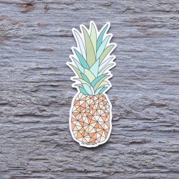 Top view of the Happy Sea Sunny Pineapple sticker on a rustic wood background