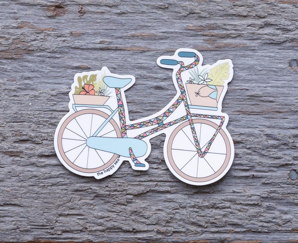 Top view of the Happy Sea Tropicalia Bicycle sticker on a rustic wood background